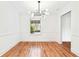 Dining room featuring a modern chandelier, large windows, and classic trim details at 67 Delmont Ne Dr, Atlanta, GA 30305