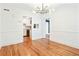 Stylish dining area features hardwood floors, a modern light fixture, and kitchen view at 67 Delmont Ne Dr, Atlanta, GA 30305