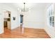 Elegant dining room with modern chandelier, hardwood floors, and classic white trim at 67 Delmont Ne Dr, Atlanta, GA 30305