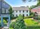 Attractive white house with lush landscaping and a welcoming neighborhood entrance gate at 67 Delmont Ne Dr, Atlanta, GA 30305