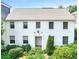 Lovely two-story white home with symmetrical windows and manicured front garden at 67 Delmont Ne Dr, Atlanta, GA 30305
