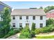 Classic white two-story home with symmetrical windows and well-maintained front garden at 67 Delmont Ne Dr, Atlanta, GA 30305