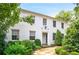 Classic white home with well-maintained landscaping and inviting curb appeal on a sunny day at 67 Delmont Ne Dr, Atlanta, GA 30305