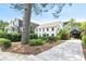 Exterior view featuring a white two-story home with a private driveway and lush landscaping at 67 Delmont Ne Dr, Atlanta, GA 30305