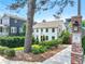 Beautiful two-story white house with manicured landscaping and a neighborhood entrance sign at 67 Delmont Ne Dr, Atlanta, GA 30305