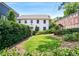 Charming home featuring lush landscaping, manicured lawn, and classic architectural details at 67 Delmont Ne Dr, Atlanta, GA 30305