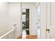 Hallway showcasing hardwood floors and access to a bathroom with hexagon tile at 67 Delmont Ne Dr, Atlanta, GA 30305