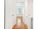 Hallway view featuring hardwood floors, white trim, and doors with brass hardware at 67 Delmont Ne Dr, Atlanta, GA 30305