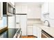 A well appointed kitchen with stainless steel appliances, white cabinetry, and a subway tile backsplash at 67 Delmont Ne Dr, Atlanta, GA 30305