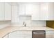 Well-lit kitchen featuring white cabinets, subway tile backsplash, and stainless steel dishwasher at 67 Delmont Ne Dr, Atlanta, GA 30305