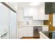 Modern kitchen with stainless steel appliances, white cabinets, and tiled backsplash at 67 Delmont Ne Dr, Atlanta, GA 30305