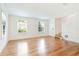 Sun-filled living room with gleaming hardwood floors, white trim, and a staircase, ready for personalization at 67 Delmont Ne Dr, Atlanta, GA 30305