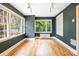 A spacious living room featuring hardwood floors, a mini-split air conditioner, and many large windows at 67 Delmont Ne Dr, Atlanta, GA 30305
