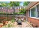 Cozy brick patio with sitting area and charming fence at 67 Delmont Ne Dr, Atlanta, GA 30305