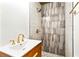 Shower in the bathroom featuring patterned tile, pebble floor, and stylish gold fixtures at 67 Delmont Ne Dr, Atlanta, GA 30305