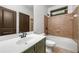 Comfortable bathroom featuring tub-shower combination with tiled walls, and a modern vanity at 2005 Eagle Rdg, Roswell, GA 30076