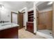 Bathroom with granite countertop, walk-in shower, and built-in shelving providing both style and function at 2005 Eagle Rdg, Roswell, GA 30076