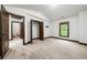 Bedroom featuring neutral carpet, white walls, and multiple entry doors at 2005 Eagle Rdg, Roswell, GA 30076