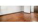 Bedroom featuring hardwood flooring, white walls, and a brown entry door at 2005 Eagle Rdg, Roswell, GA 30076