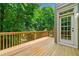 The wooden deck has a natural view, railing, and access to the home's interior at 2005 Eagle Rdg, Roswell, GA 30076