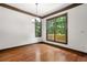 Traditional dining room with hardwood floors, chandelier, and picturesque backyard views through large windows at 2005 Eagle Rdg, Roswell, GA 30076
