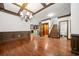 Open dining room with hardwood floors and decorative ceilings, adjacent to an elevator, stairs, and kitchen at 2005 Eagle Rdg, Roswell, GA 30076