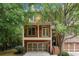Charming brick home with a two-car garage and second story balcony surrounded by mature trees at 2005 Eagle Rdg, Roswell, GA 30076