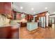 Bright kitchen with stainless steel appliances, central island, tile backsplash, and hardwood floors at 2005 Eagle Rdg, Roswell, GA 30076