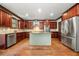 Spacious kitchen with center island, stainless appliances, custom cabinets, and hardwood flooring at 2005 Eagle Rdg, Roswell, GA 30076