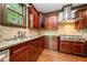 Well-equipped kitchen featuring custom cabinetry, stainless appliances, granite countertops, and hardwood floors at 2005 Eagle Rdg, Roswell, GA 30076