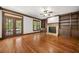 Open-concept living room featuring hardwood floors, fireplace, and built-in shelving at 2005 Eagle Rdg, Roswell, GA 30076