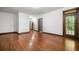 Open living area with rich hardwood floors and an abundance of natural light flowing from a glass paneled exterior door at 2005 Eagle Rdg, Roswell, GA 30076