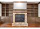 Comfortable living room with hardwood floors and built-in shelving surrounding fireplace at 2005 Eagle Rdg, Roswell, GA 30076