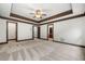 Large main bedroom featuring tray ceiling, carpet, and multiple doorways at 2005 Eagle Rdg, Roswell, GA 30076