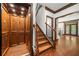Elegant staircase with hardwood steps, decorative iron railings, and a residential elevator at 2005 Eagle Rdg, Roswell, GA 30076