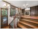 Hardwood staircase leading to living room with fireplace and built-in shelving at 2005 Eagle Rdg, Roswell, GA 30076