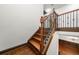 Staircase with hardwood steps and decorative iron railings at 2005 Eagle Rdg, Roswell, GA 30076