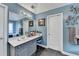 Bathroom featuring single vanity with granite countertops, modern lighting, and large framed mirror at 2730 Henderson Chase Ct, Tucker, GA 30084