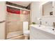 Bathroom featuring double sink vanity and shower with patterned tile accent at 3880 Admiral Dr, Chamblee, GA 30341