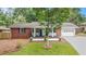 Charming brick home with a cozy front porch, blue accents, and a well-manicured lawn at 3880 Admiral Dr, Chamblee, GA 30341