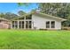 Back exterior view showing large, grassy yard and multiple windows at 3880 Admiral Dr, Chamblee, GA 30341