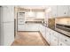 Bright kitchen with white cabinetry, granite countertops, and tiled floors at 3880 Admiral Dr, Chamblee, GA 30341