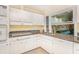 Bright kitchen featuring white cabinetry, granite countertops, and views to an outside sitting area at 3880 Admiral Dr, Chamblee, GA 30341
