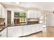 Open kitchen with white cabinets, granite countertops and tile floors with natural light at 3880 Admiral Dr, Chamblee, GA 30341