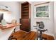Office with built-in bookshelves, desk, exercise bike, and hardwood floors at 3880 Admiral Dr, Chamblee, GA 30341