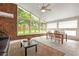 Sunroom with floor to ceiling windows, dining table, wood paneling, and neutral decor at 3880 Admiral Dr, Chamblee, GA 30341
