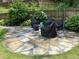 Outdoor patio with stone pavers, covered furniture and a fire pit, perfect for entertaining at 158 Delano Dr, Decatur, GA 30032