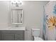 Bathroom featuring modern vanity with sleek countertop and a shower with a decorative shower curtain at 1589 Delano Dr, Decatur, GA 30032