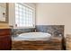 Claw-foot soaking tub with stone and brick accents and large window at 1589 Delano Dr, Decatur, GA 30032