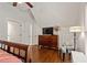 This bedroom features hardwood floors, a dresser with television and a seating area at 1589 Delano Dr, Decatur, GA 30032